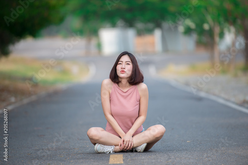Portrait of asian woman sit on the road,Beautiful thailand people,Happy woman concept,Lifestyle of modern girl