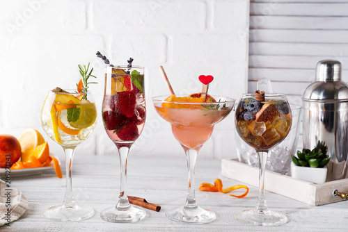 Different alcoholic drink in glass with Bar accessories on white wooden background