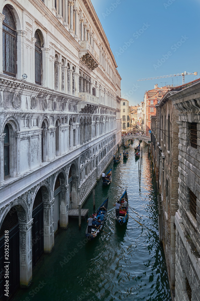 Venice, Italy. View from Bridge of Sighs. Traditional narrow canal with boats in Venice, Italy