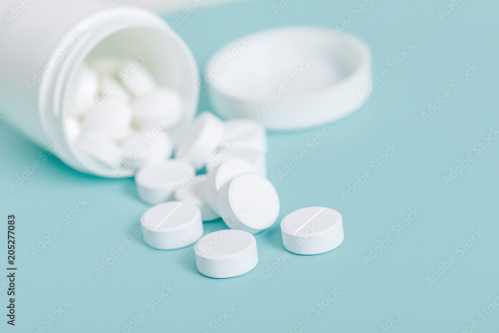 Pills spilling out of pill bottle Pills spilling out of pill bottle