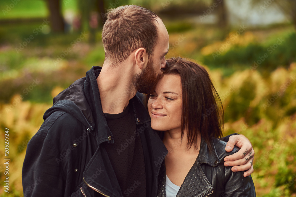 Happy modern couple in a park. Enjoying their love and nature. Happy modern couple in a park. Enjoying their love and nature.