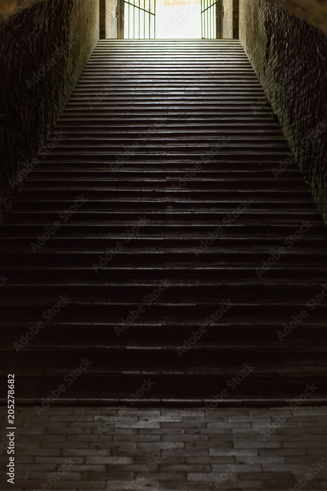 Staircase in aged fortress with dramatic light Staircase in aged fortress with dramatic light