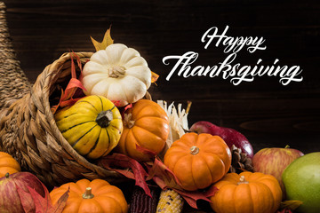 A Thanksgiving holiday decorative cornucopia with pumpkins, squash, leaves etc