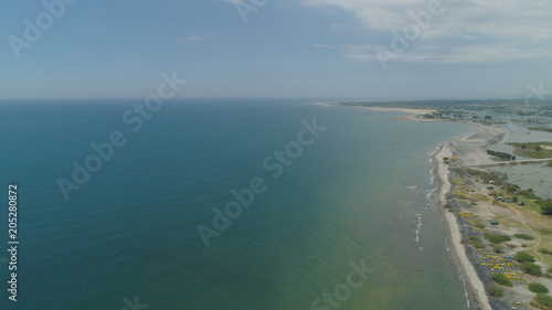 Aerial view of coastline with sandy beach, azure water on the island Luzon, Philippines. Seascape, ocean and beautiful beach. Agoo Damortis National Seashore Park. photo