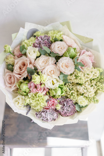flower arrangement. multicolor bouquet of beautiful flowers on wooden table. Floristry concept. Spring colors. Vertical photo