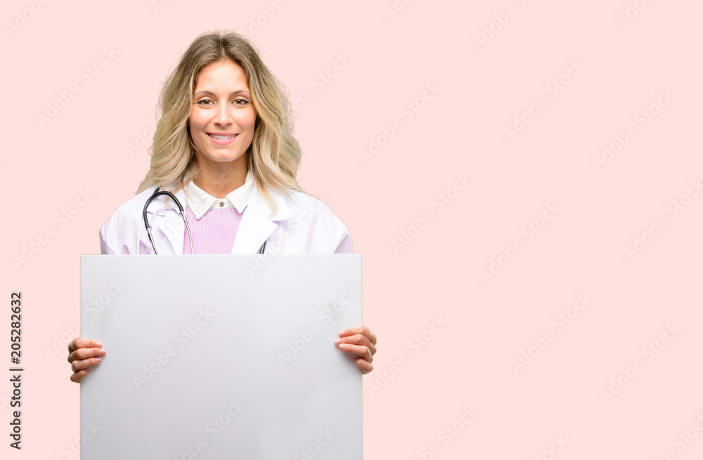 Young doctor woman, medical professional holding blank advertising banner, good poster for ad, offer or announcement, big paper billboard Young doctor woman, medical professional holding blank advertising banner, good poster for ad, offer or announcement, big paper billboard