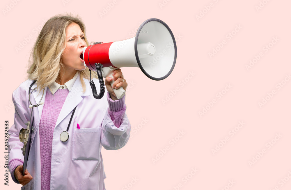 Young doctor woman, medical professional communicates shouting loud holding a megaphone, expressing success and positive concept, idea for marketing or sales Young doctor woman, medical professional communicates shouting loud holding a megaphone, expressing success and positive concept, idea for marketing or sales