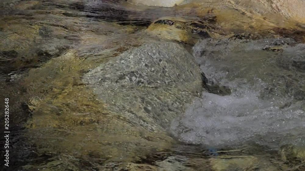 Beautiful water in a mountain river in slow motion video. Shooting speed 180fps, slow motion. Live shooting of the most beautiful nature river mountain water. The camera is static. Beautiful water in a mountain river in slow motion video. Shooting speed 180fps, slow motion. Live shooting of the most beautiful nature river mountain water. The camera is static.