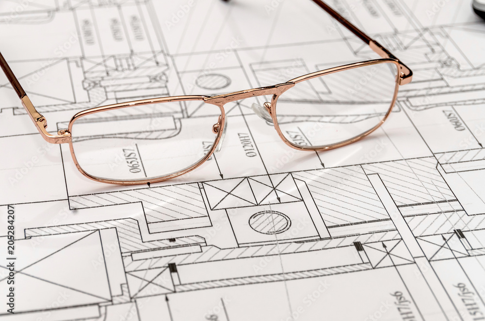 Engineer's drawing with spectacles, close up . Engineer's drawing with spectacles, close up .