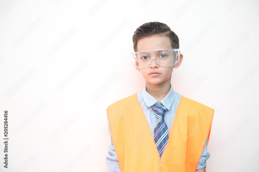 Young boy engineer isolated in white. Handsome early teenage boy portrait with engineering cloth. Confident look pose. Young boy engineer isolated in white. Handsome early teenage boy portrait with engineering cloth. Confident look pose.