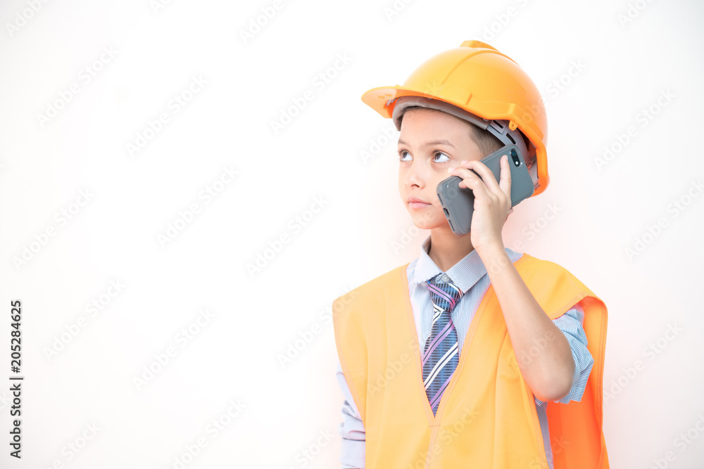 Young boy engineer isolated in white. Handsome early teenage boy portrait with engineering cloth. Talking on mobile phone. Young boy engineer isolated in white. Handsome early teenage boy portrait with engineering cloth. Talking on mobile phone.