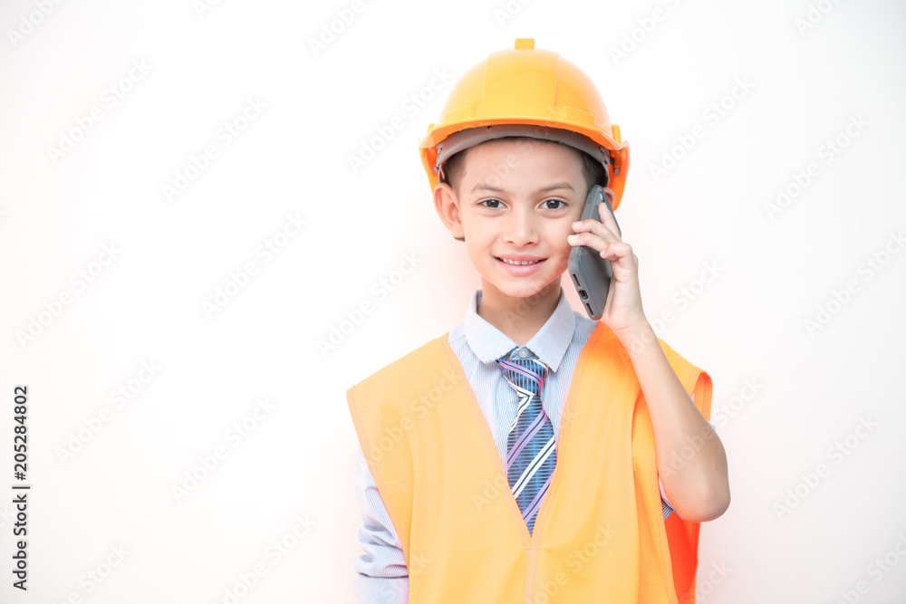 Young boy engineer isolated in white. Handsome early teenage boy portrait with engineering cloth. Talking on mobile phone. Young boy engineer isolated in white. Handsome early teenage boy portrait with engineering cloth. Talking on mobile phone.