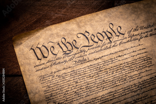 A copy of the Constitution of the United Sates of American on a wooden background photo