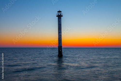 Skew lighthouse in the Baltic Sea. Late sunset time. Kiipsaare, Harilaid, Saaremaa, Estonia, Europe.