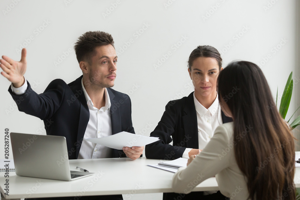 Male HR manager pointing at door, asking female job candidate to leave, colleagues not satisfied with recruitment process and applicant. Concept of bad interview, stubbornness, unsuccessful employment