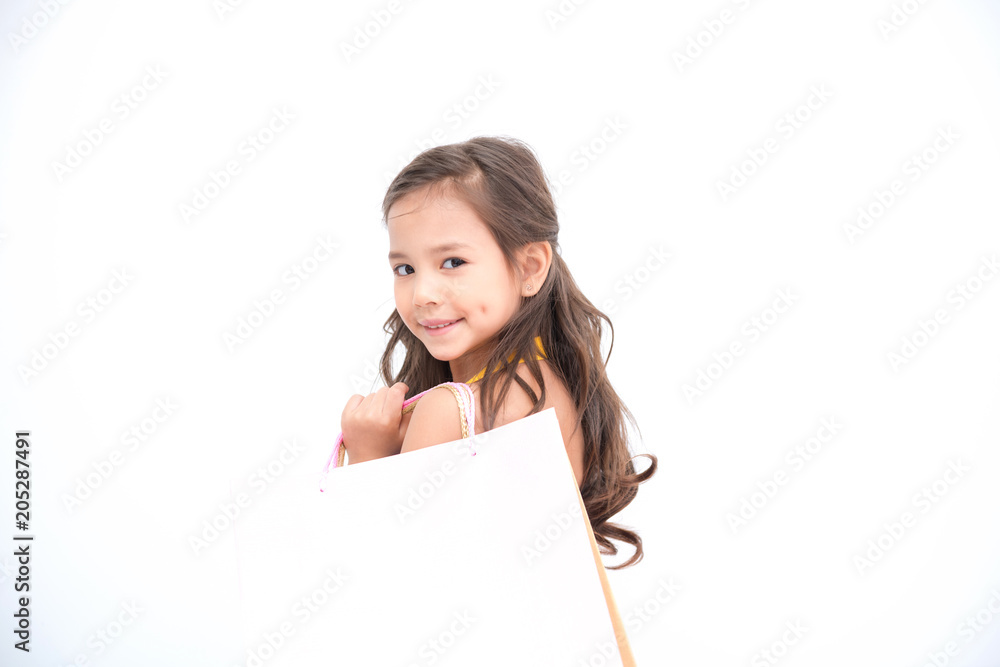Young shopper girl isolated white. Pretty early teenage girl portrait. With shopping bag and smile happy pose. Young shopper girl isolated white. Pretty early teenage girl portrait. With shopping bag and smile happy pose.