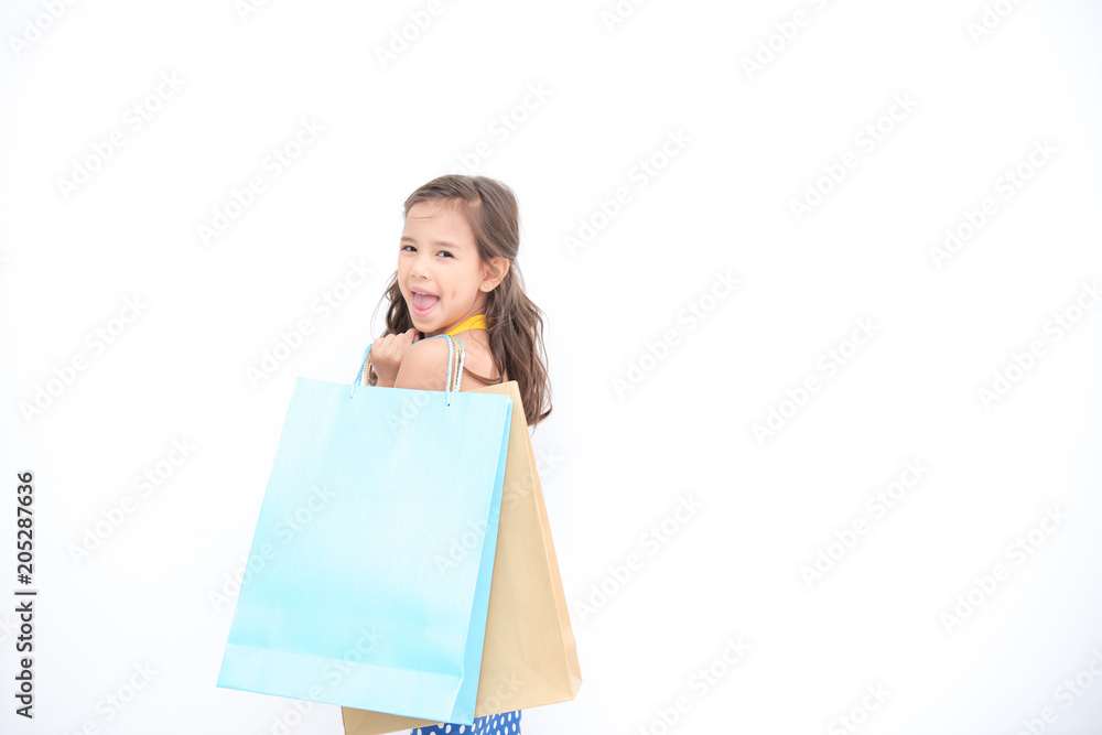 Young shopper girl isolated white. Pretty early teenage girl portrait. With shopping bag and smile happy pose. Young shopper girl isolated white. Pretty early teenage girl portrait. With shopping bag and smile happy pose.