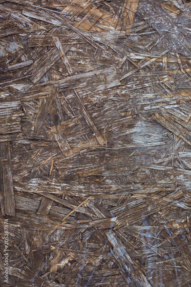 Old weathered chipboard texture close-up Old weathered chipboard texture close-up