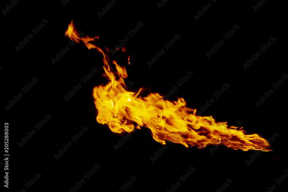Fire, flame on a black background. Fire for advertising. An unusual game of bright red and yellow colors.