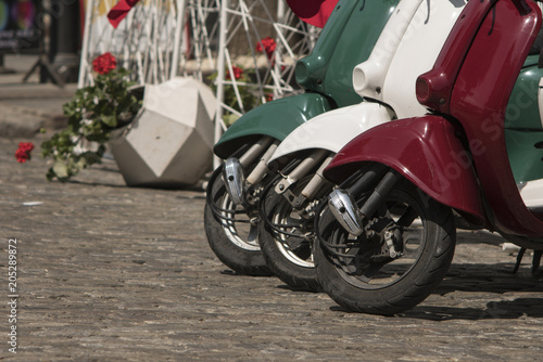 three mopeds painted in colors of the Italian flag © Yurii Romanov