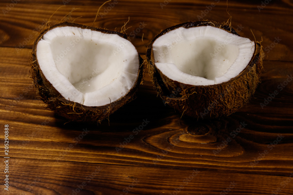 Fresh ripe coconut on rustic wooden table Fresh ripe coconut on rustic wooden table