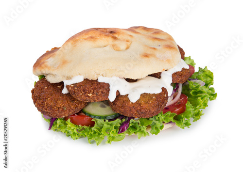 falafel with fresh vegetables in pita bread on white.