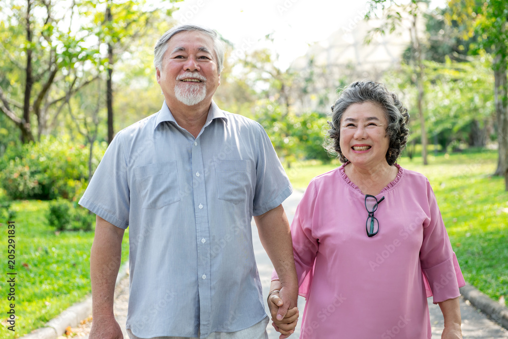 Senior couple in park portrait. Chinese old couple in park, relaxing, smiling. Medium shot. Senior couple in park portrait. Chinese old couple in park, relaxing, smiling. Medium shot.