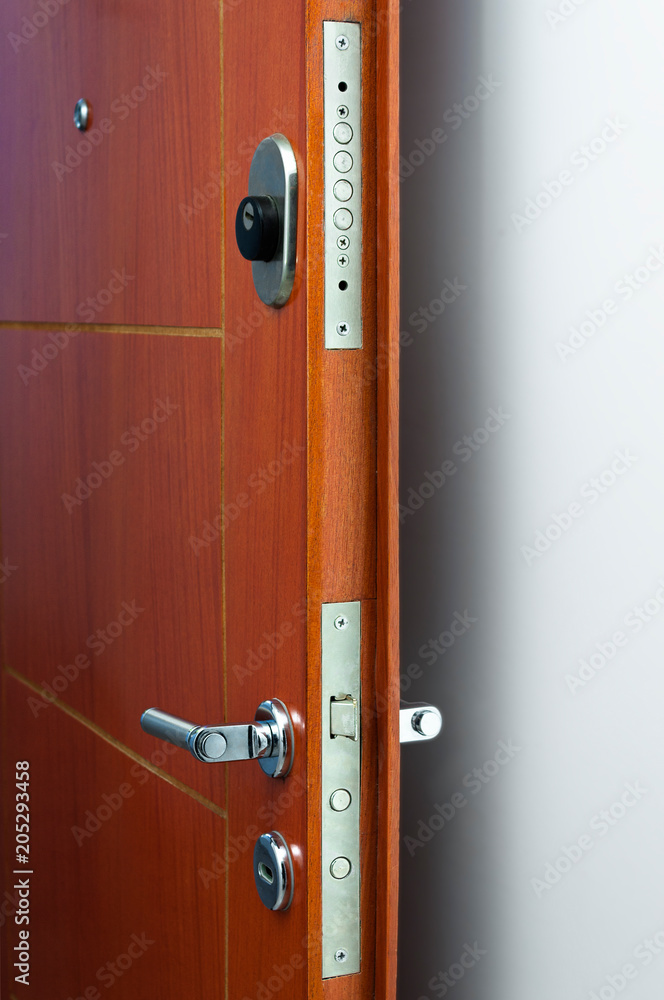 Obraz premium Open door of a family home. Close-up of the lock an armored door.