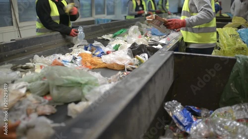 Workers Hands sorting Plastic waste moving on Conveyor, Garbage sorting Station