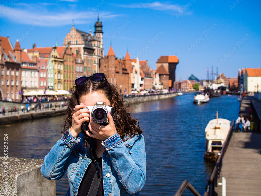 Obraz Young woman taking pictures