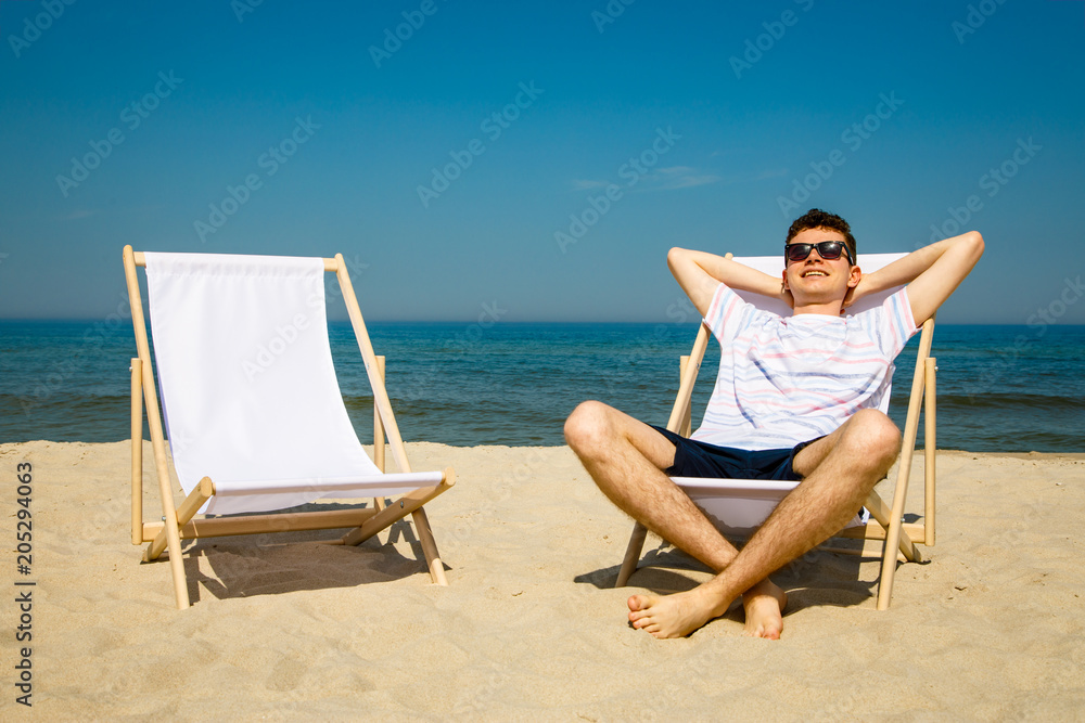 Young man relaxing on beach