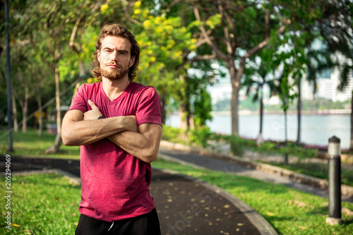 Portrait of very fit sport man in park.