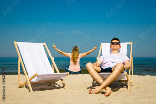 Woman and man relaxing on beach