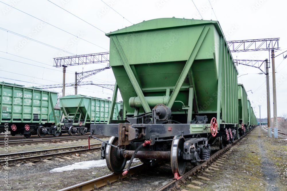 The green car is on the rails. The green car is on the rails.
