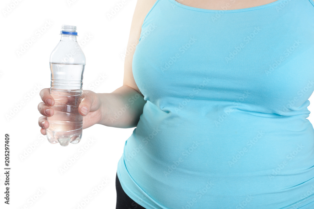 Woman with overweight (obesity) holds a bottle of water in his hand. Concept of diet and weight loss Woman with overweight (obesity) holds a bottle of water in his hand. Concept of diet and weight loss