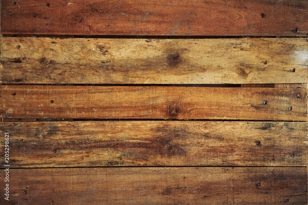 Top view of rustic, weathered uneven textured wooden planks. Top view of rustic, weathered uneven textured wooden planks.