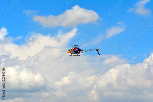 Homemade radio control helicopter on blue sky.