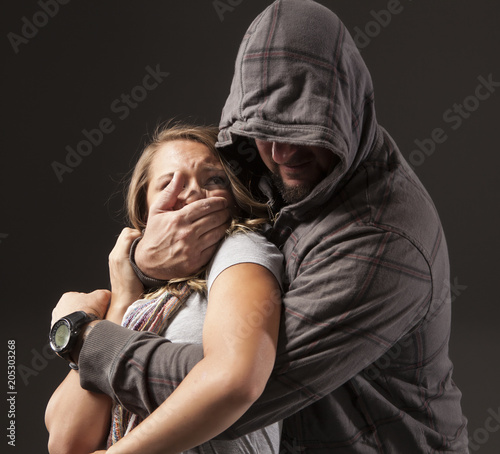 Girl is frightened as she's being grabbed by a stranger.