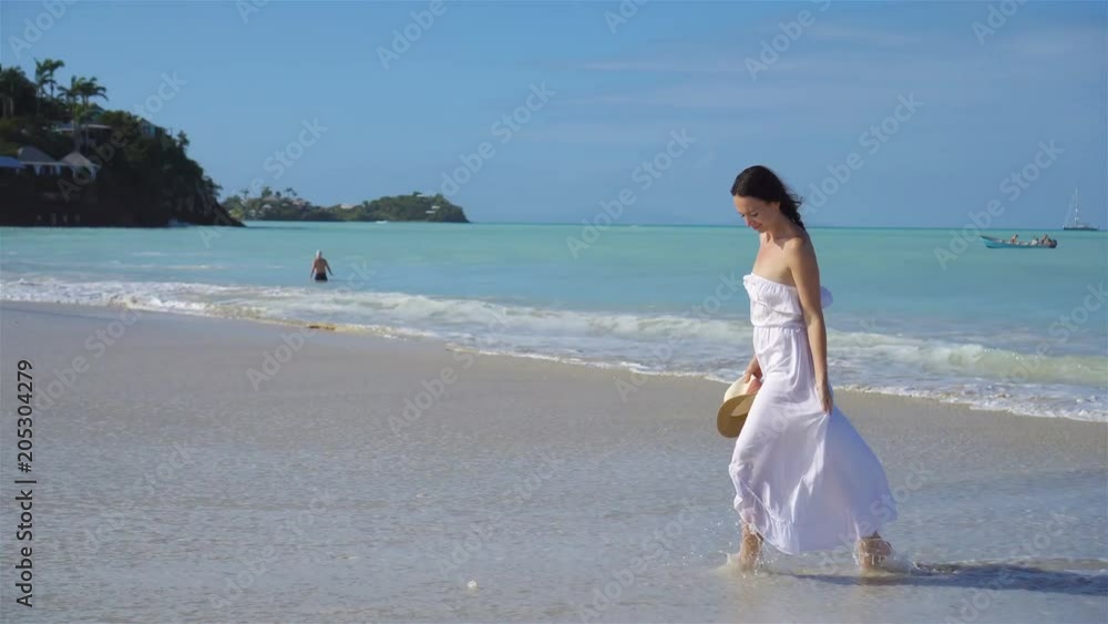 Young beautiful woman on white sand tropical beach. Young beautiful woman on white sand tropical beach.