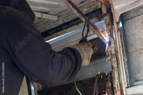 Worker welding the steel part by manual