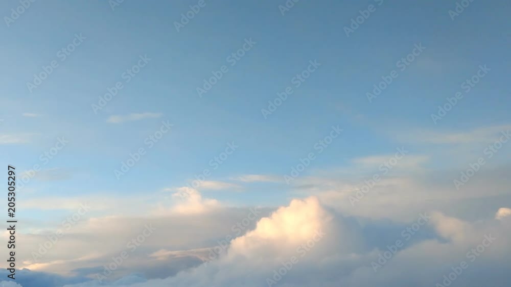 Cloudscape out window of airplane at sunset Cloudscape out window of airplane at sunset