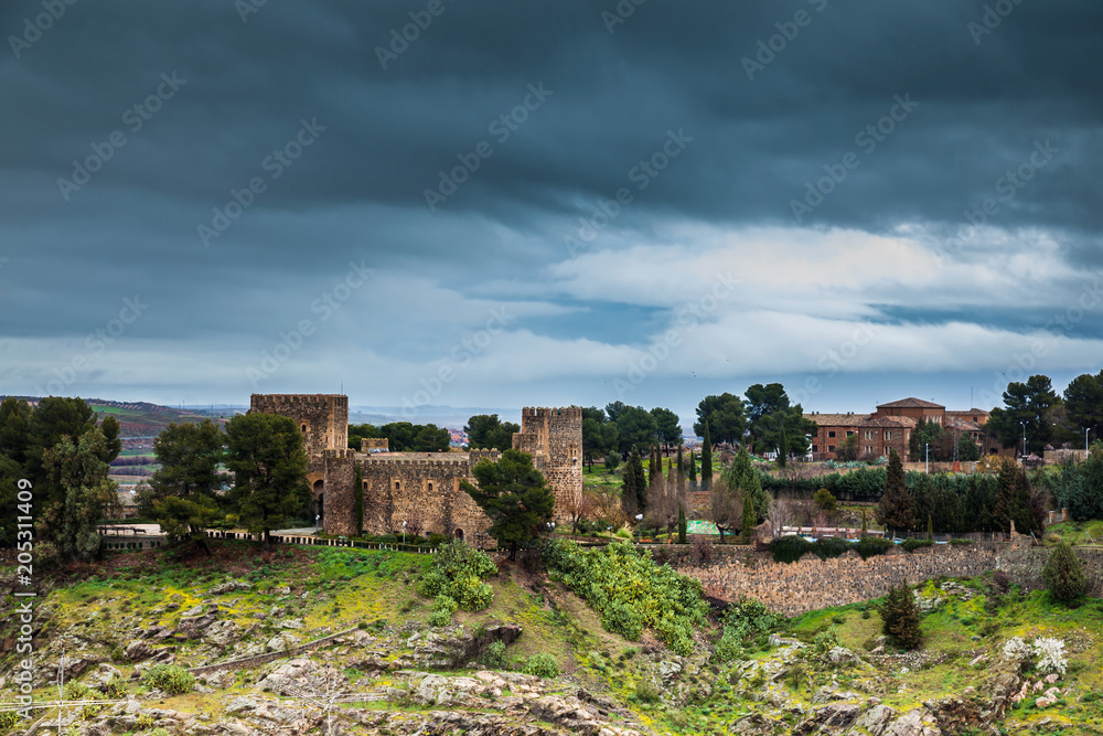 Castle of San Servando under storm clouds