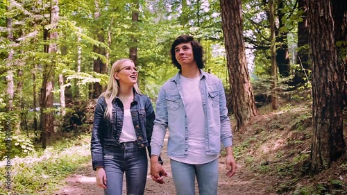 Young Couple Walking, Hand In Hand, Through Forest