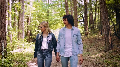 Young Couple Walking, Hand In Hand, Through Forest