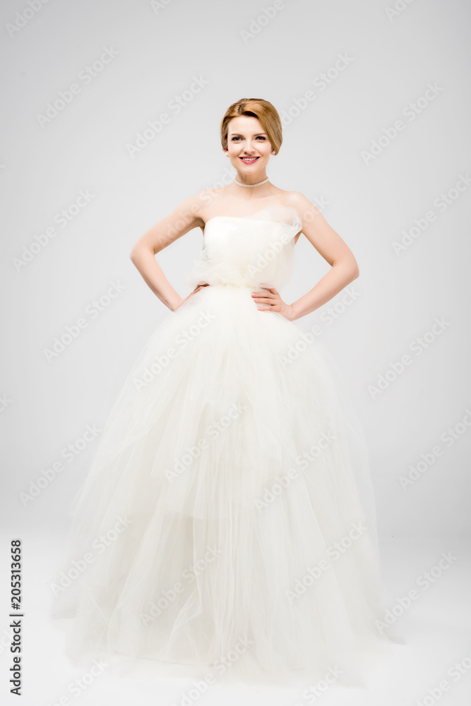 beautiful bride in white wedding dress, isolated on grey