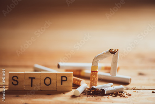 World No Tobacco Day, May 31. Close up Broken cigarette with STOP text on Wooden Block on wooden table background. photo