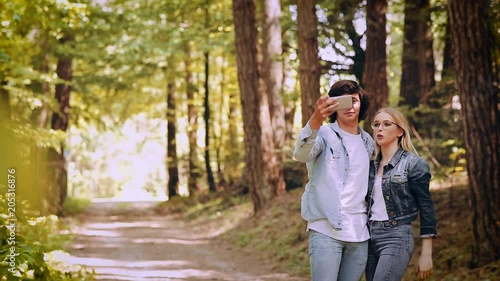 Young Couple Taking Selfie On A Forest Walking