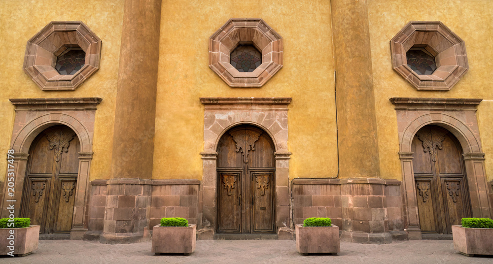 Mexican colonial style house in Queretaro Mexico, classic wood doors and decorative windows. Mexican colonial style house in Queretaro Mexico, classic wood doors and decorative windows.