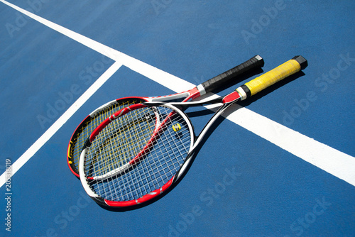 Couple of tennis raquets on the court
