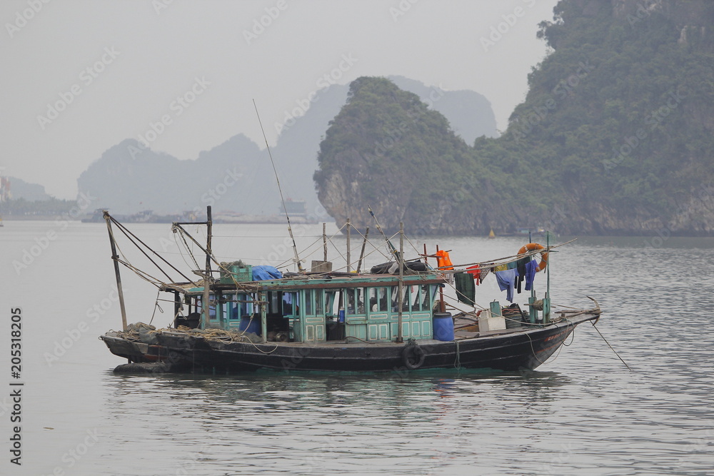 Ha Long Bay , Vietnam-29 November 2014:Fishing boat in Ha long Bay, Panoramic view of sunset in Halong Bay, Vietnam, Southeast Asia,UNESCO World Heritage Site